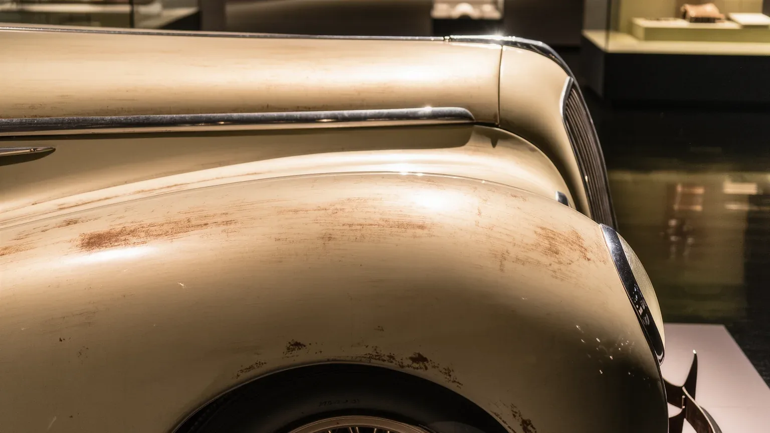 Close view of a rusted wing on an unrestored classic car