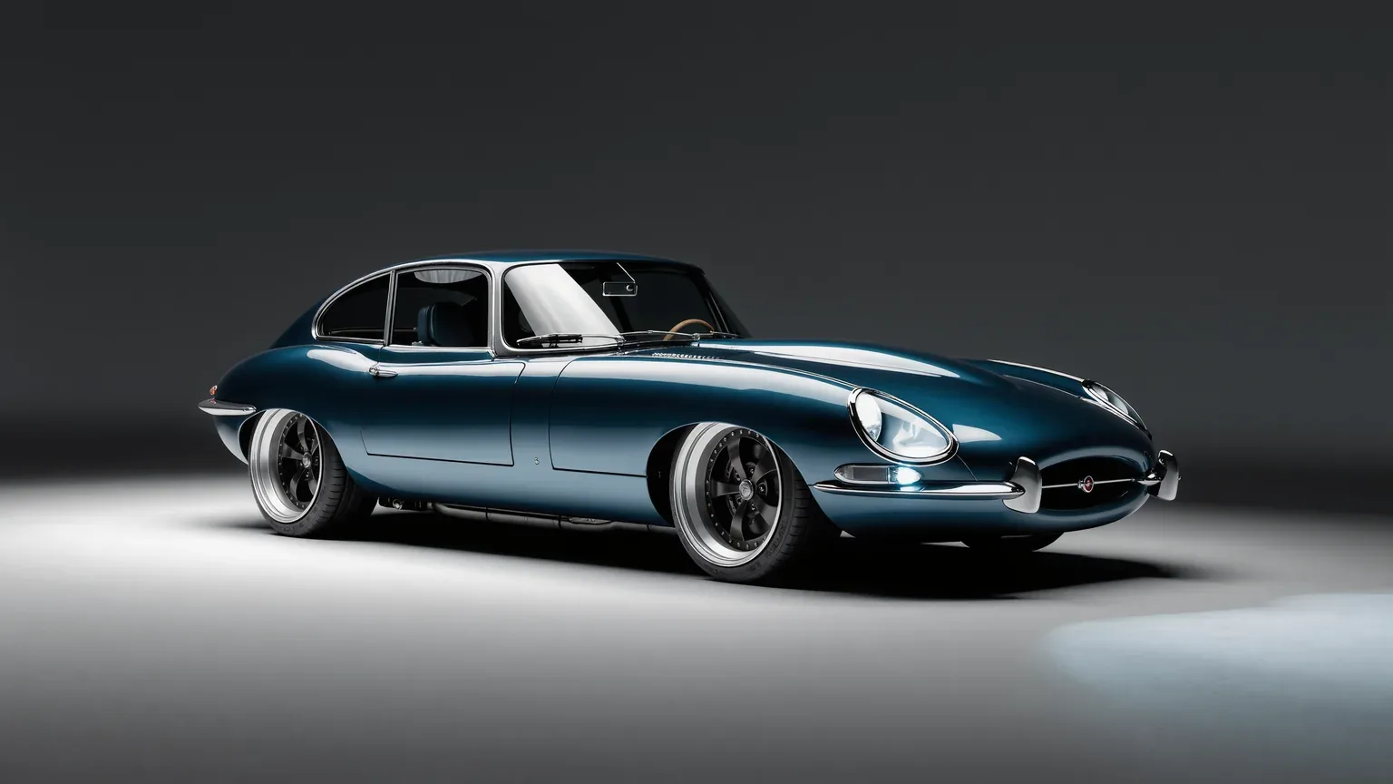 A classic sports car standing still in a plain studio setting